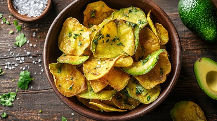 Bowl of crispy avocado chips with herbs and sea salt